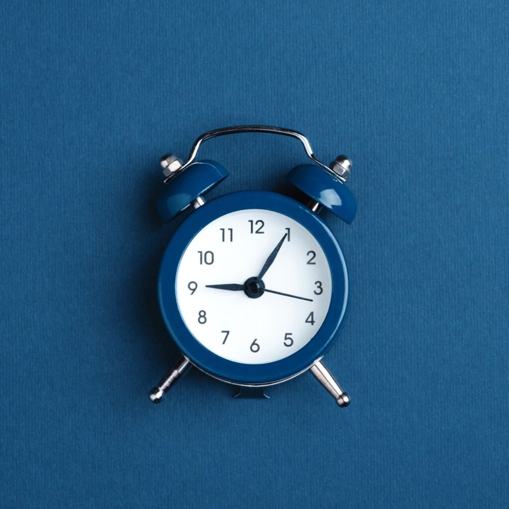 classic alarm clock on blue background