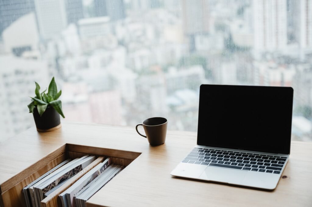 light apartment interior with minimalist workplace and transparent chair and table