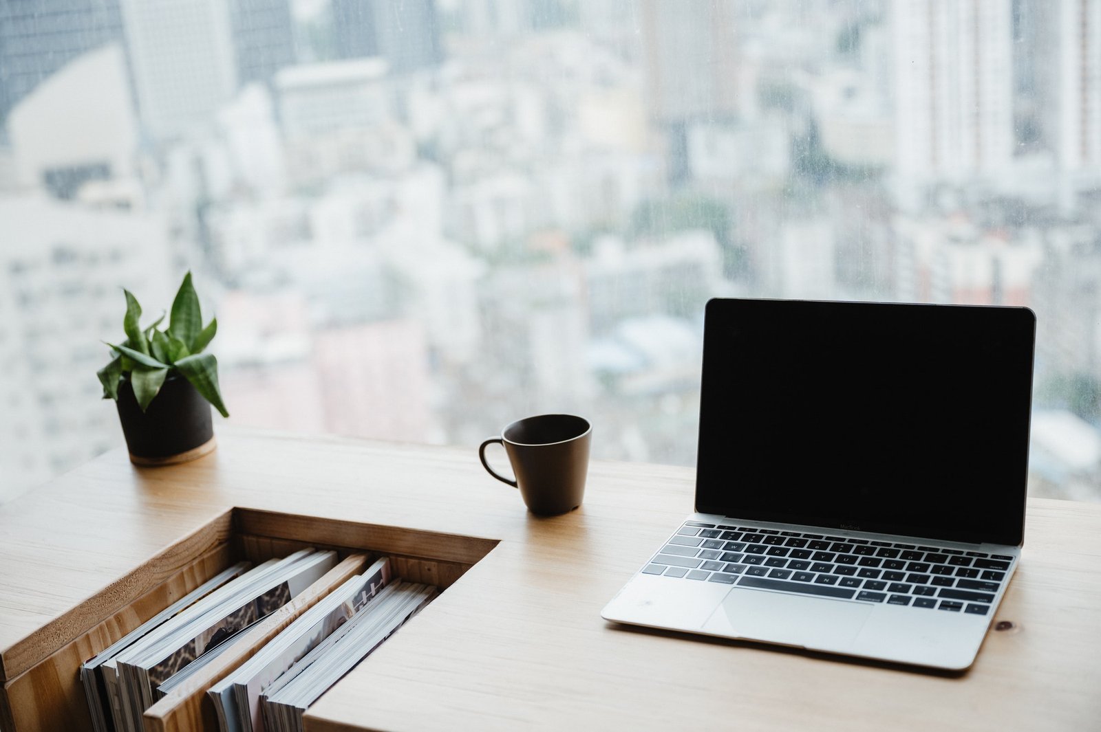 light apartment interior with minimalist workplace and transparent chair and table