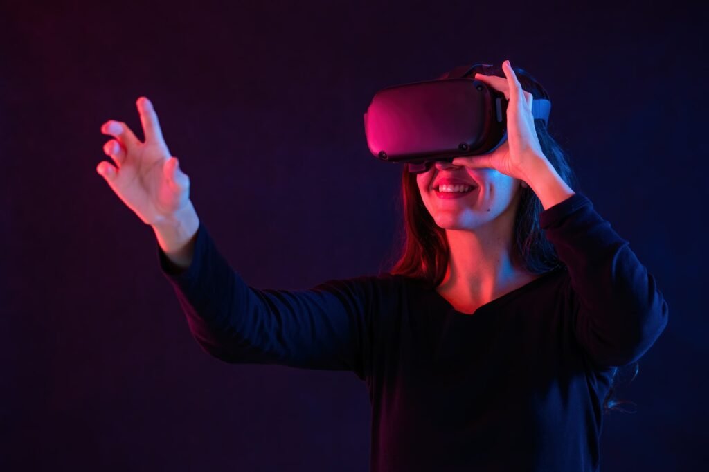 smiling woman with headset interacting in virtual reality